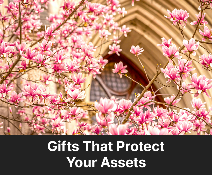Cherry blossom trees infront of a building. Links to Gifts That Protect Your Assets